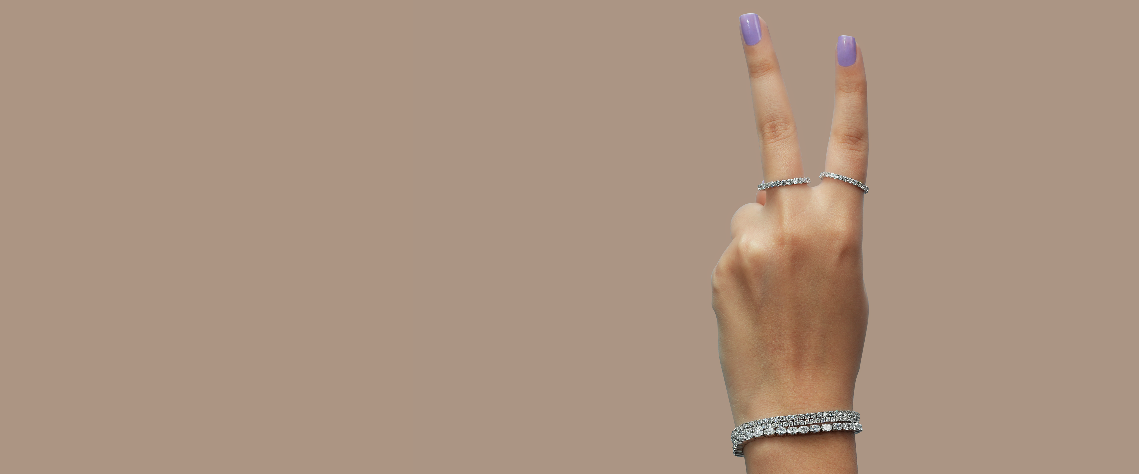 banner is presenting lab diamond bracelet on a girl hand also 2 diamond rings are showing on finger